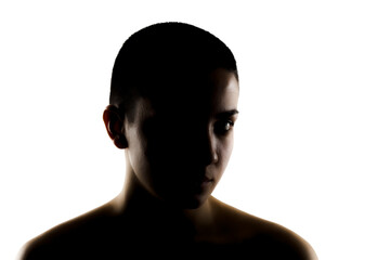 Silhouette portrait of a beautiful young woman with very short hair against white background.
