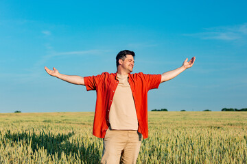 Stylish man stand in wheat field in summer