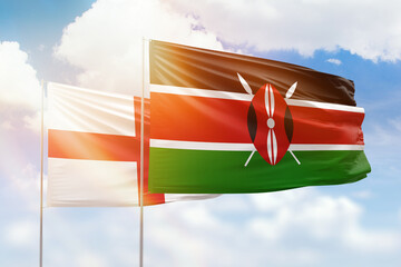 Sunny blue sky and flags of kenya and england