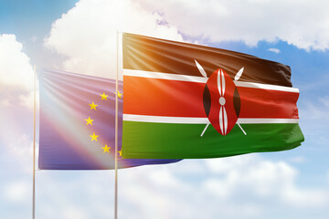 Sunny blue sky and flags of kenya and european union