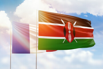 Sunny blue sky and flags of kenya and france