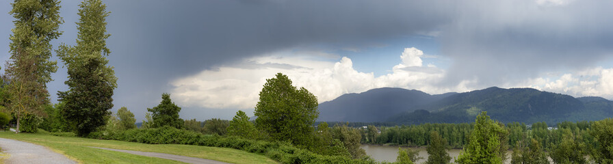 Panoramic View of Fraser River Heritage Park. Cloudy Spring Season Sky. Fraser River Heritage Park, Mission, British Columbia, Canada.
