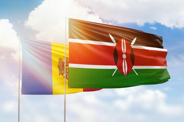 Sunny blue sky and flags of kenya and moldova