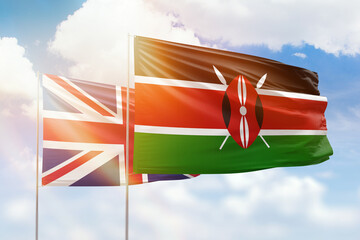 Sunny blue sky and flags of kenya and united kingdom