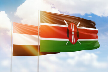 Sunny blue sky and flags of kenya and yemen