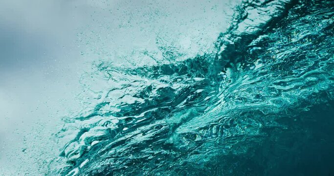 Stormy blue ocean wave breaking in ultra slow motion