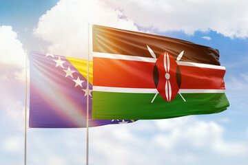 Sunny blue sky and flags of kenya and bosnia