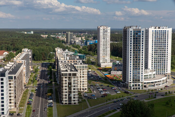 Fototapeta premium Landscape from the height of the city with beautiful modern houses in the summer afternoon. Belarus is the capital city of Minsk. Europe.