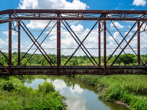 Rusty metal bridge over a creek