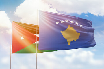Sunny blue sky and flags of kosovo and jordan