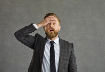 Damn, I forgot. Upset man in suit, shirt and necktie slaps hand on forehead as he remembers...
