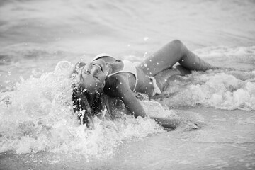 Beautiful, sexy, woman enjoying the sea waves on the beach. - obrazy, fototapety, plakaty