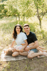 Happy family with daughter in sunshine outdoors