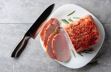 Smoked ham with rosemary and kitchen knife.