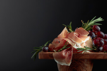 Prosciutto with grapes and rosemary.