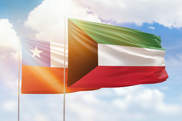 Sunny blue sky and flags of kuwait and chile