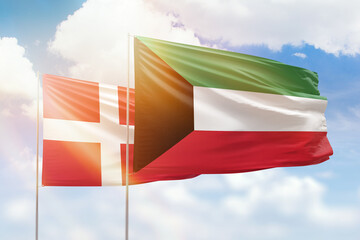 Sunny blue sky and flags of kuwait and denmark