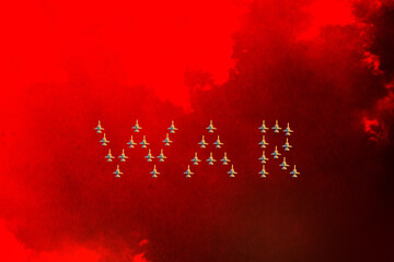 Fighters in the sky. A group of fighters against the red sky lined up in the word war