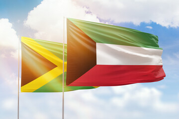 Sunny blue sky and flags of kuwait and jamaica