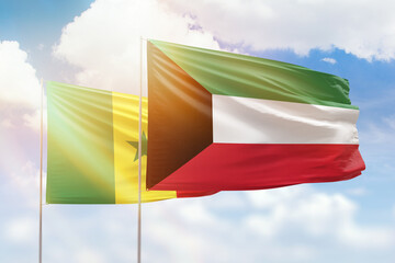 Sunny blue sky and flags of kuwait and senegal
