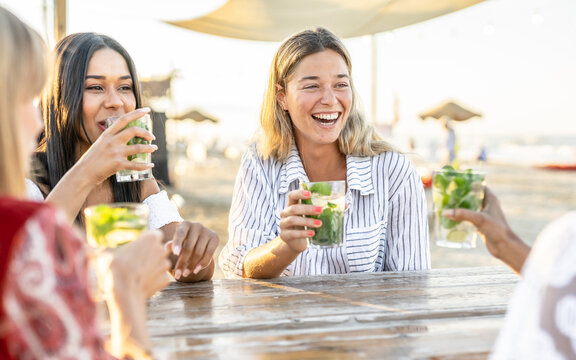 Young Attractive Women Drink Mojito On The Beach While Listening Chill Music - Travel, Fun, Vacation Concept