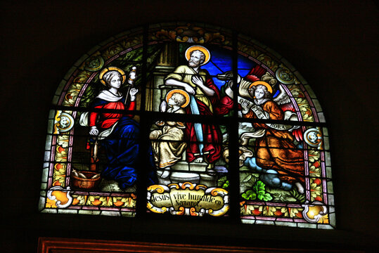 Stained glass. Window. Stained glass windows in church. Stained glass windows in the Basílica de San Francisco, Salta, Argentina. Religious images. 
Saints, angels.  Jesus lives humble in Nazaret. 