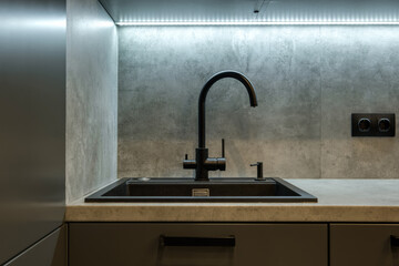 Black water tap sink with faucet in expensive kitchen
