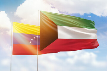 Sunny blue sky and flags of kuwait and venezuela