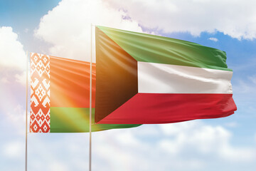 Sunny blue sky and flags of kuwait and belarus