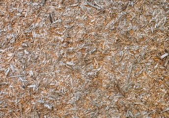Background, texture of a pressed wooden board, sawdust on the wall. Photography, abstraction.