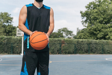 Young boy with the basketball in his hands ready to shoot a free throw. Close-up frontal image of a...