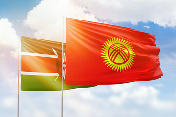 Sunny blue sky and flags of kyrgyzstan and kenya