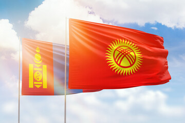 Sunny blue sky and flags of kyrgyzstan and mongolia
