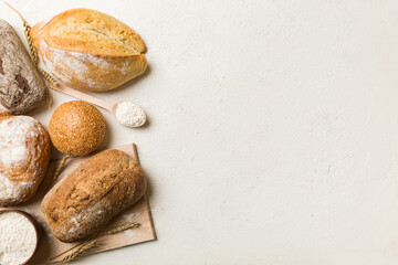 Homemade natural breads. Different kinds of fresh bread as background, top view with copy space