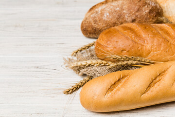 Homemade natural breads. Different kinds of fresh bread as background, perspective view with copy space