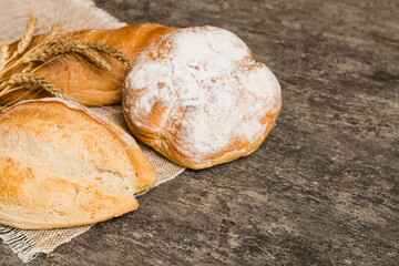 Homemade natural breads. Different kinds of fresh bread as background, perspective view with copy space
