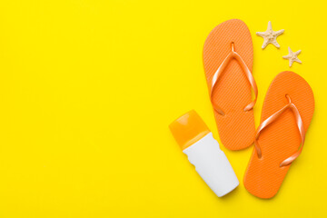 Flat lay composition with flip flops and seashell on colored background. Space for text top view