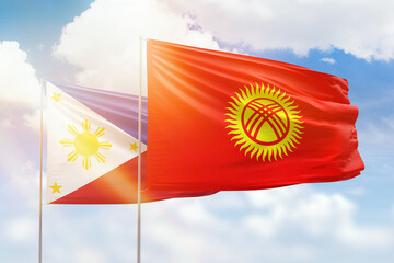 Sunny blue sky and flags of kyrgyzstan and philippines