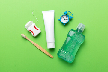 Mouthwash and other oral hygiene products on colored table top view with copy space. Flat lay....