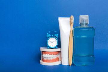 Mouthwash and other oral hygiene products on colored table top view with copy space. Flat lay....