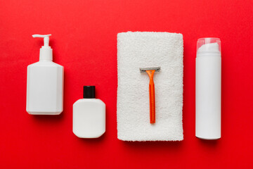 shaving man set. shaving machine, towel, lotion and shaving foam on colored background. Men bath Accessories top view