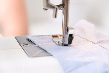 A man sews clothes on a sewing machine. Hobbies, needlework, creativity.