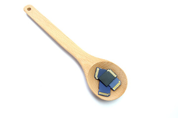 Wooden spoon and four SD memory cards on an isolated white background.