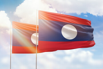 Sunny blue sky and flags of laos and laos
