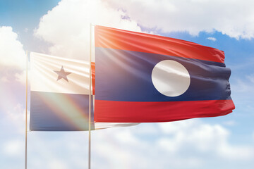 Sunny blue sky and flags of laos and panama