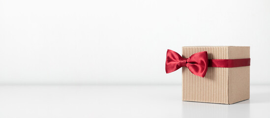 Happy Father's Day. Gift box on with red bow tie. Father's day holiday greeting card.