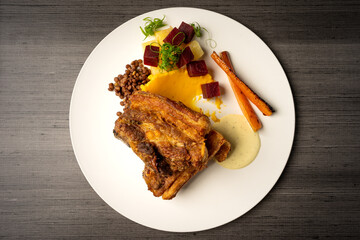 fried pork ribs with beans, salad and mashed potatoes