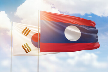 Sunny blue sky and flags of laos and south korea