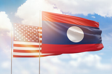 Sunny blue sky and flags of laos and usa