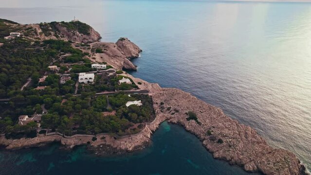 Early morning drone view of Platja de Cala Gat Beach with turquoise sea water. Spanish Town Es Pelats and Cala Ratjada from above in Majorca, Balearic Islands, Spain, drone view. 